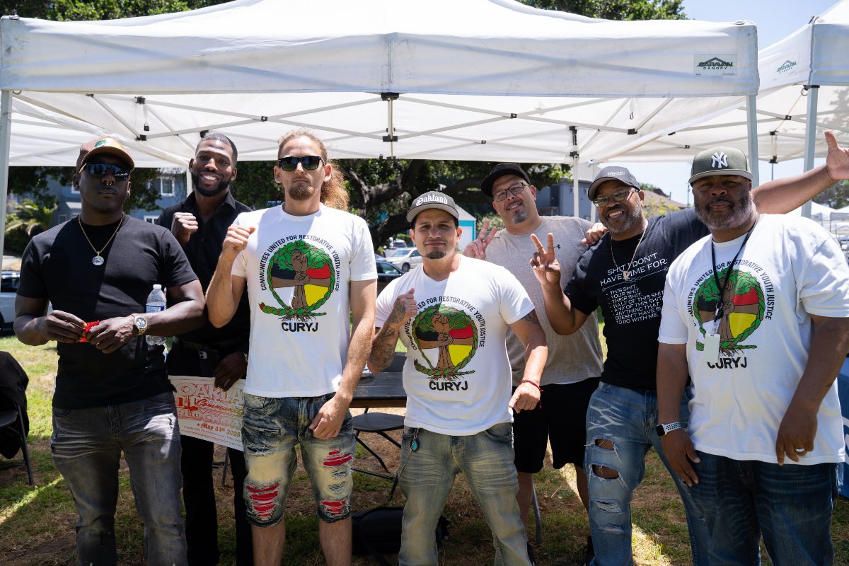 CURYJ Reps Posing in front of booth