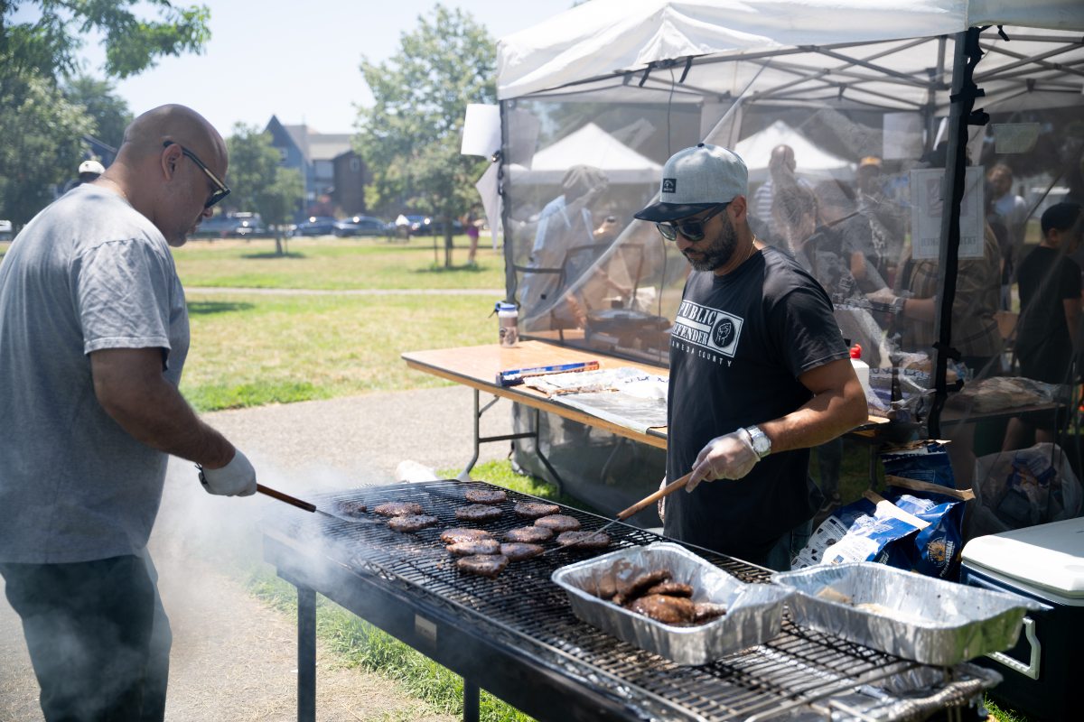 Public Defender Staff Flipping Burgers on Grill