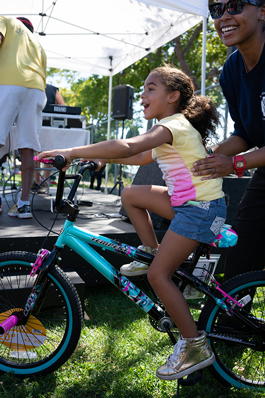 Little girl on bicycle that she won at the Block Party