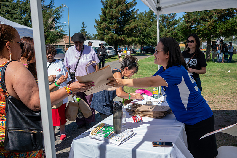 Public Defender assisting community member at Block Party