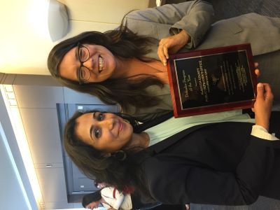 Immigration Attorneys holding CPDA Award Plaque